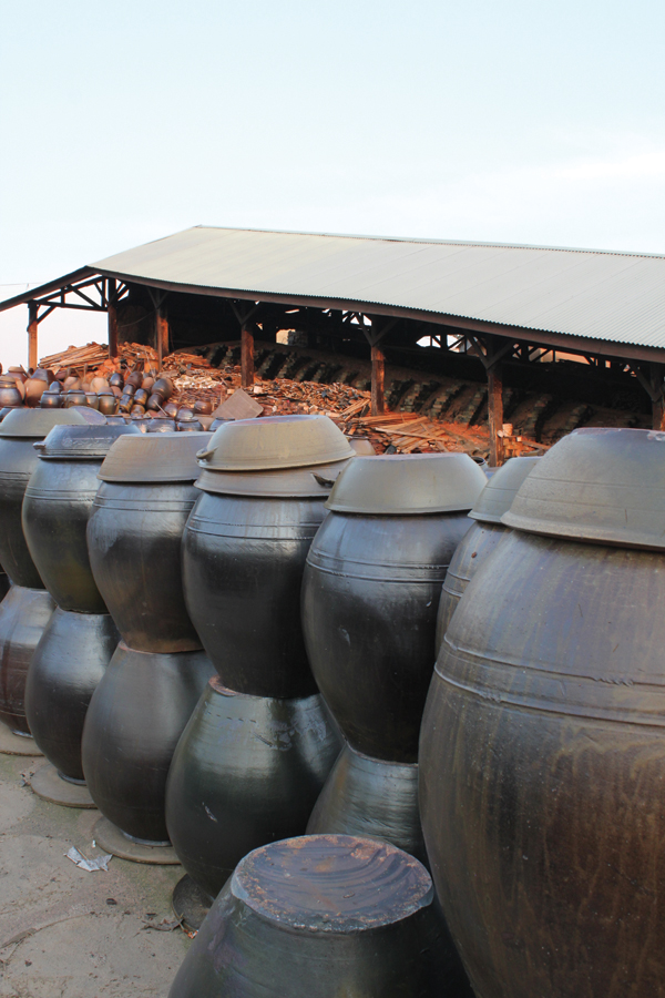 1 Finished Onggi pots stacked along the road next to a kiln that is being prepared for a firing in Oegosan Onggi Village in Ulsan, Korea (also home to the Onggi Museum and the Onggi Academy).