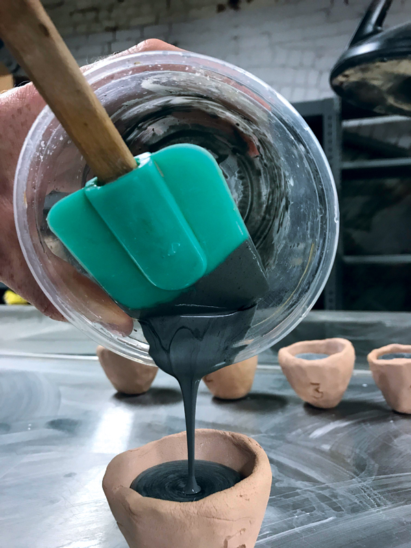 2 Pour wet-mixed ingredients into bisque-fired clay crucibles that have been dusted with alumina hydrate.