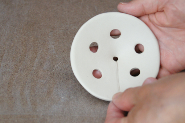 8 Score both beveled edges, add slip, then seal them together to form a cone.