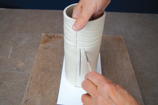 9 Reach inside the cylinder to feel that the knife is cutting through the clay.