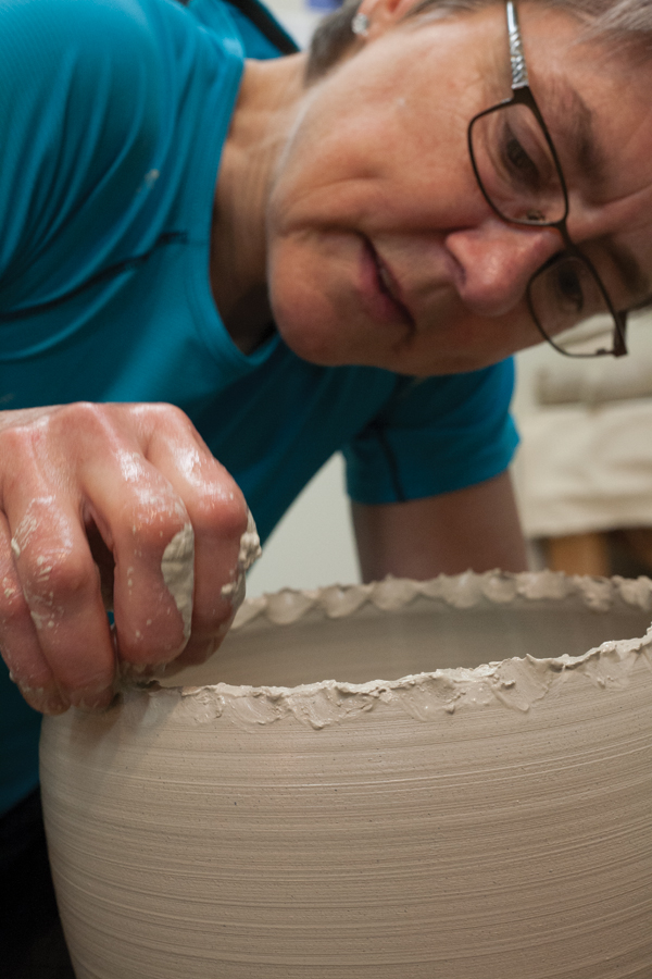2 After several pulls, pinch and tear the top of the form to create a decorative edge.