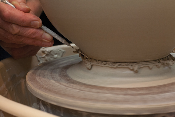 6 Use a needle tool to remove excess clay from the base of the chalice.