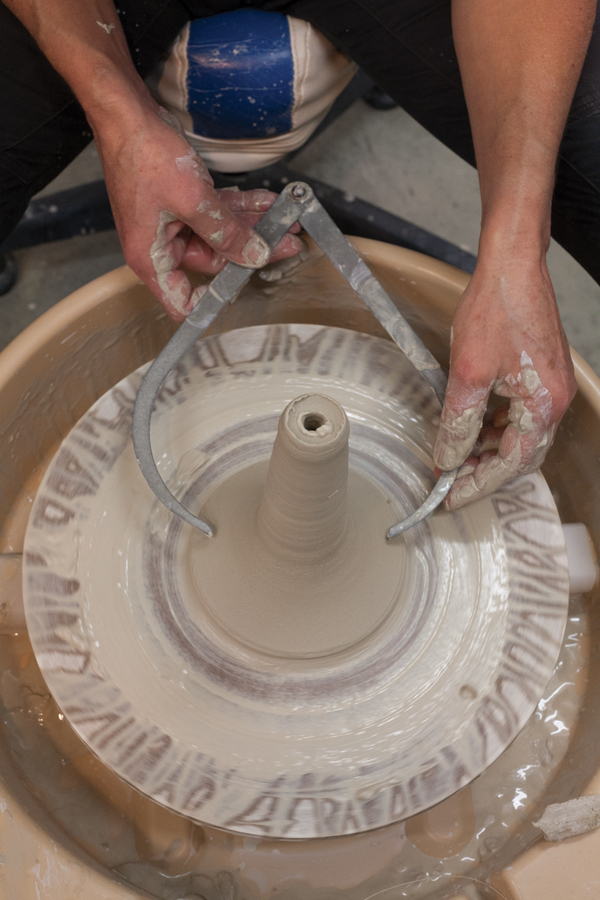 11 Use calipers to measure the diameter of the base's bottom.