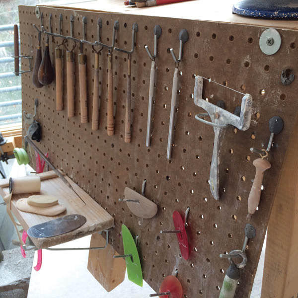 2 After hanging the hooks and testing their functionality, use epoxy putty to secure the hooks in place from both the front side and the back. 