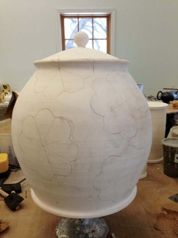 10 A bisque-fired jar with surface decorations sketched out in pencil.