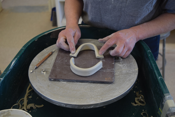 6 Pull a long, wide strap, then cut it into two halves (each about 4 inches in length) to create the handles.