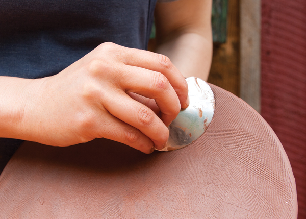 5 Try out different tools to create a variety of textures on the plate. The texture ultimately provides a quiet background for the bold slip decoration to pop.