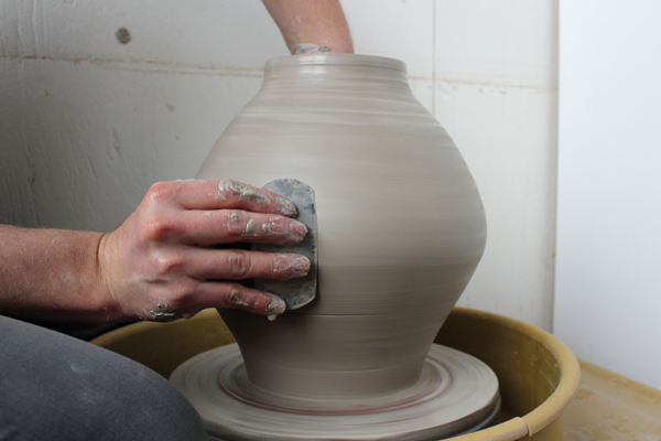 3 Shape the jar with a rib. Measure the rim opening and allow it to firm up.
