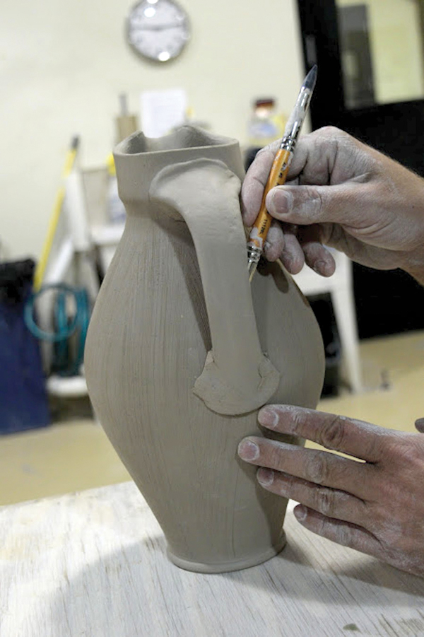 9 Add a coil to the bottom handle attachment to strengthen it.