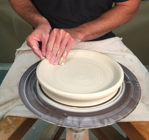 1 Pull the clay up from a centered and flattened lump to create a lip.