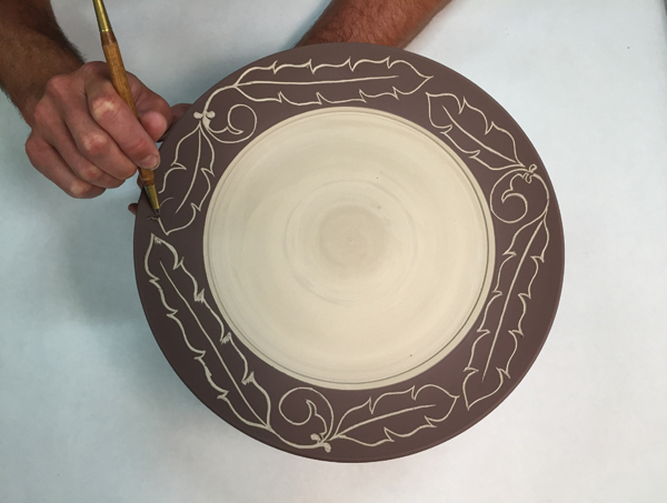 9 Use a thin-tipped carving tool to thicken up the lines and edges of the drawn image.