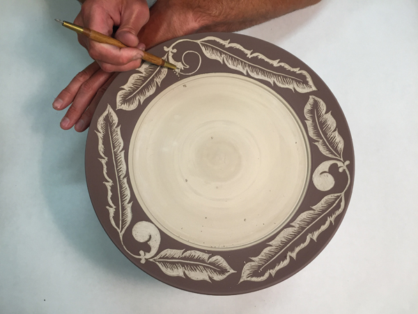10 Remove layers of underglaze to add depth to the image. Carving deeper into the clay will result in a flat white color.