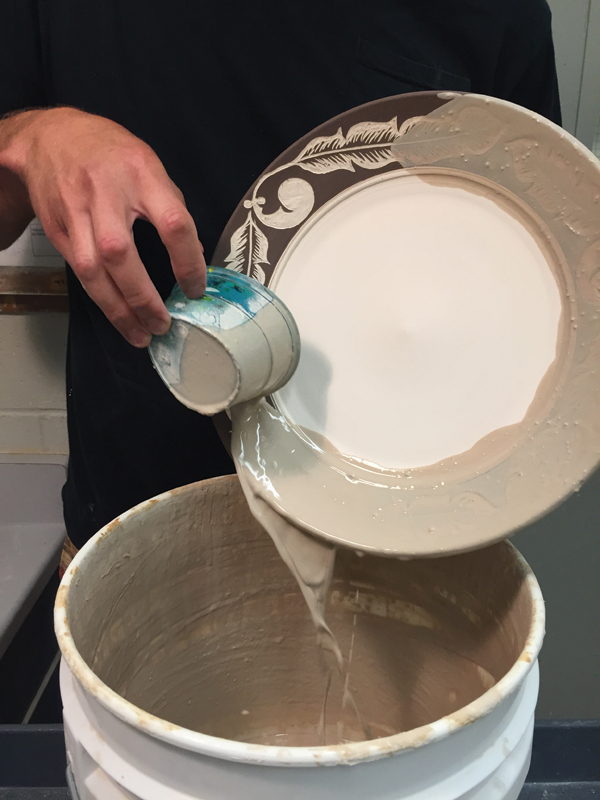 12 After bisque firing, pour a clear glaze onto the border of the plate. Glaze the underside and foot interior as well.