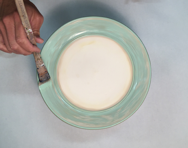 13 Allow the plate to fully dry, then coat the clear glaze with wax resist. Don’t apply wax to any part you wish to further glaze.