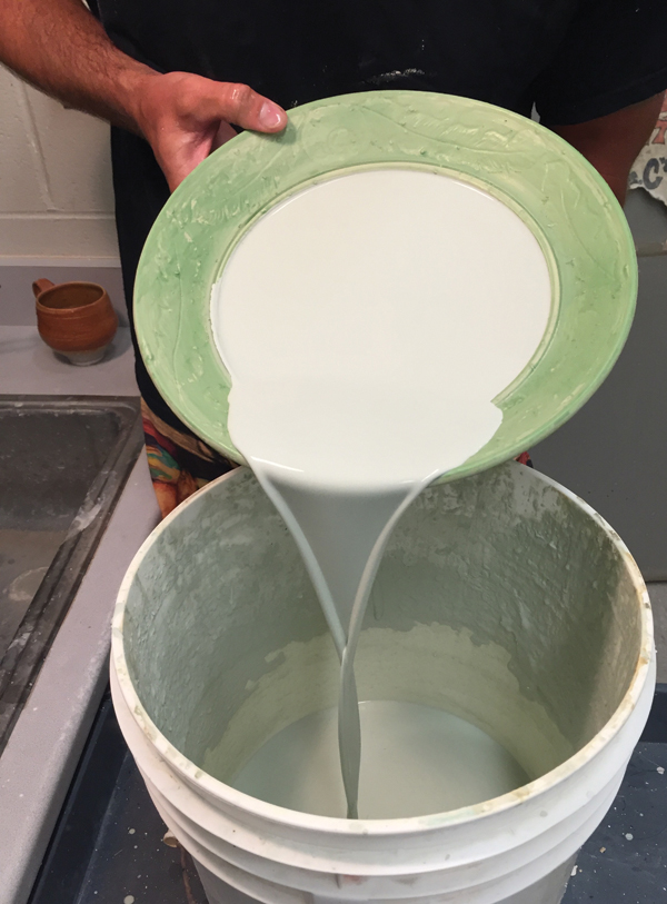 14 When the wax is dry, pour a contrasting glaze into the interior of the form, make sure it’s fully coated, then pour it out.