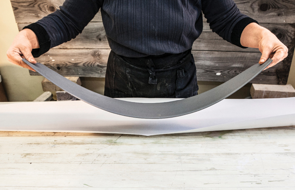 2 Stretch the clay lengthwise by holding it at the ends and fan it out as if you were throwing a sheet on the bed.