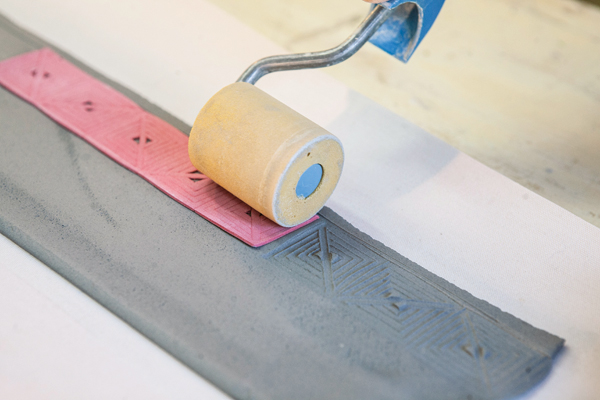 3 Stamping in the texture to print the clay with a delicate relief pattern.