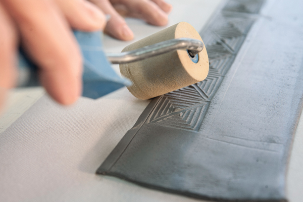 5 Using a brayer, roll over the edge at a 60° angle outward giving it a thin bevel.