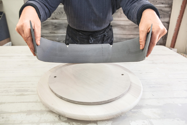 10 Curve in the slab with the palm of your hands and gently place it standing up on your work surface.