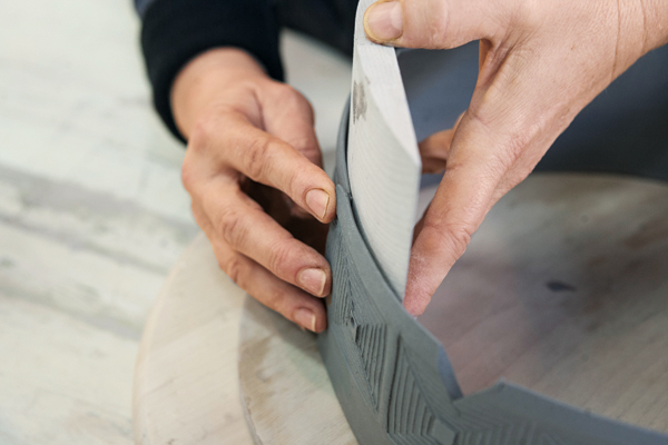 13 Support the interior of the cylinder using a wooden tool with a rounded profile.
