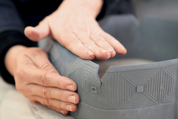 15 While supporting the walls, gently fold the tops inward so that the two cuts meet.