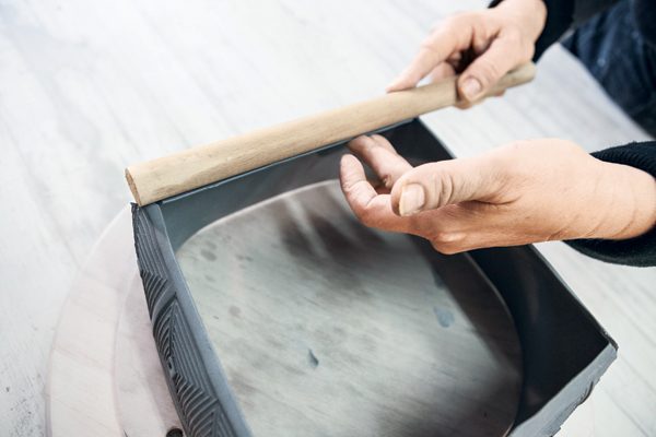 17 Straighten the bottom edges by firming them against a wooden dowel.