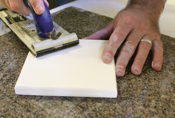 3 Sanding the square plaster tile master with drywall sandpaper before switching to finer grits of wet/dry sandpaper.