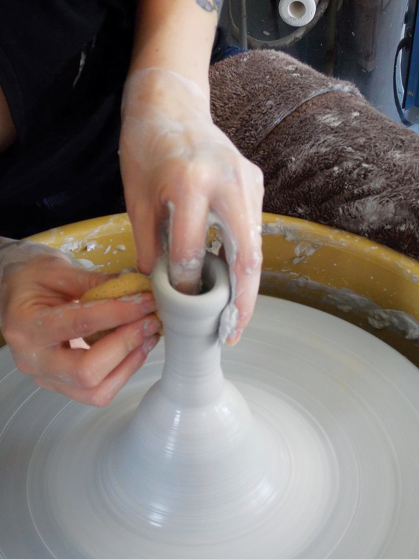 3 Throw the handle off the hump, keeping it in proportion to the scoop.