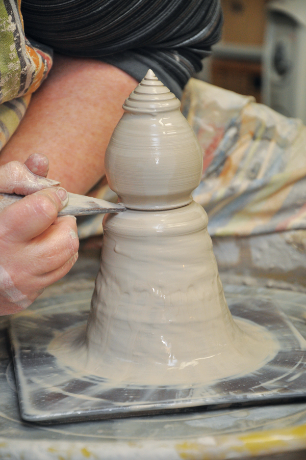 3 Use your fingers and tools to create an interesting shape. Spend time refining the tip, then use a tool to define the bottom where you’ll cut the form off of the hump.