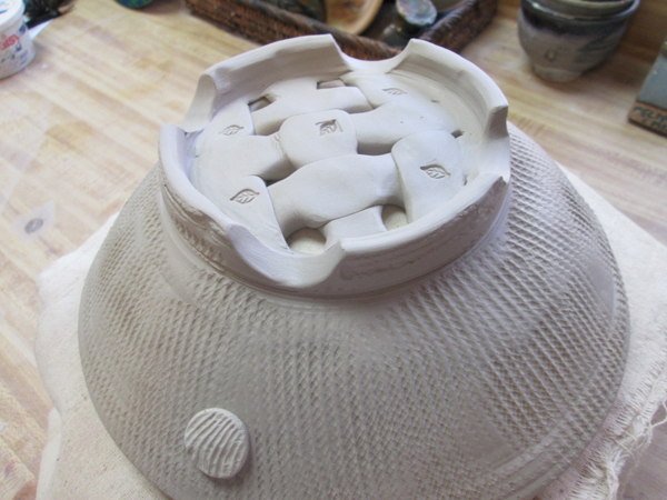 Alternatively, build fruit bowls or colanders by cutting a circle out of the middle bottom of a thrown or slab-built bowl and add a small weaving.