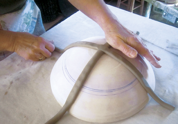 1 First cross two coils on a convex plaster hump mold. The coils are 1-inch in diameter and are extruded for uniformity.