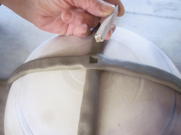 2 Stamping the middle of the first cross makes it easier to keep track of the middle once more coils are added.