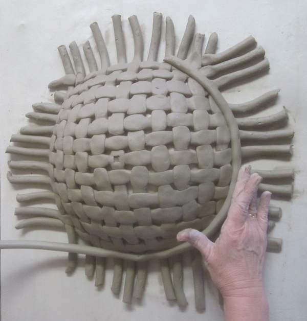 5 Attach a coil rim to the outside circumference of the woven bowl. Cut the ends that will be joined at a 45° angle.