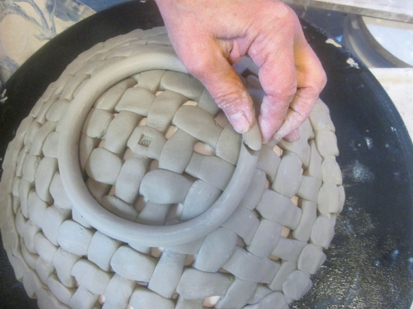 8 Mark the placement for a foot ring with a pin tool, place a coil on top, cut the two ends of the coil at a 45° angle, then attach.