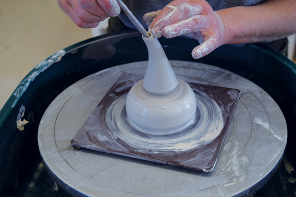 2 Make the spout opening smaller by pulling up with a needle tool handle inside, then bend the spout before removing it.