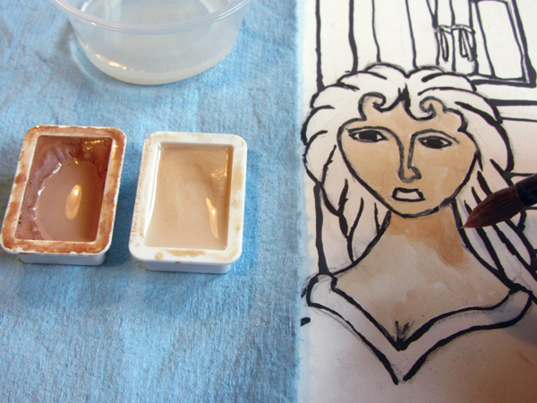 3 Start adding AMACO watercolor underglaze using assorted brushes. A paper towel protects areas from any drips of underglaze watercolor.