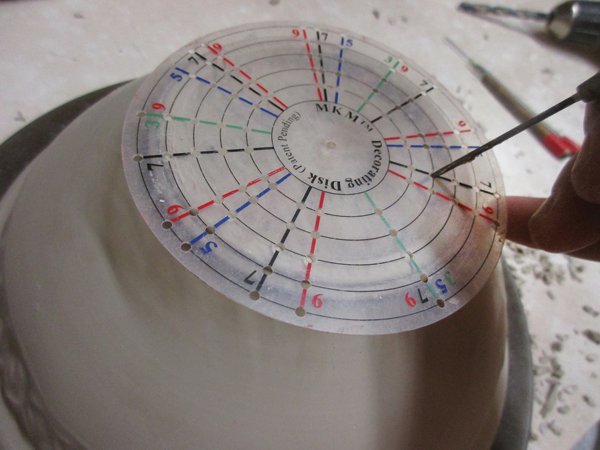 2 Use a MKM Decorating Disk to determine where the holes will go, and mark with a needle tool.