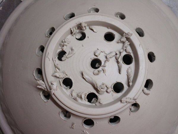 4 Clean up any burrs left from the drilling after the bowl has become bone dry.