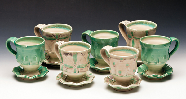 2 Tea cups and saucers, 5 in. (13 cm) in height, wheel-thrown white stoneware, slip decoration, glaze, electric fired to cone 6, 2014. Photo: Bob Payne.