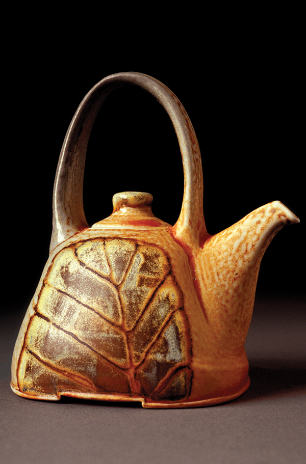 5 Yixing teapot, 4 in. (10 cm) in height, wheel-thrown and altered porcelanous stoneware, Helmer Kaolin Slip, Green Slip, brown Mason stain in terra sigillata outline, Warren MacKenzie Shino Glaze (liner), salt/soda fired to cone 10, 2004. Photo: John Sinal.